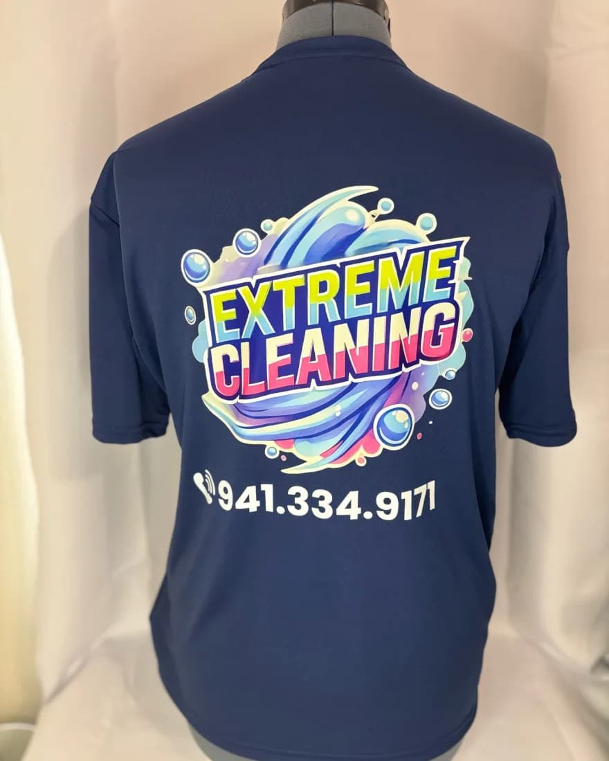 Navy tee with a full-color Extreme Cleaning logo and phone number on the back